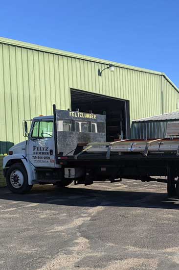 Feltz Lumber flat bed truck outside of facility